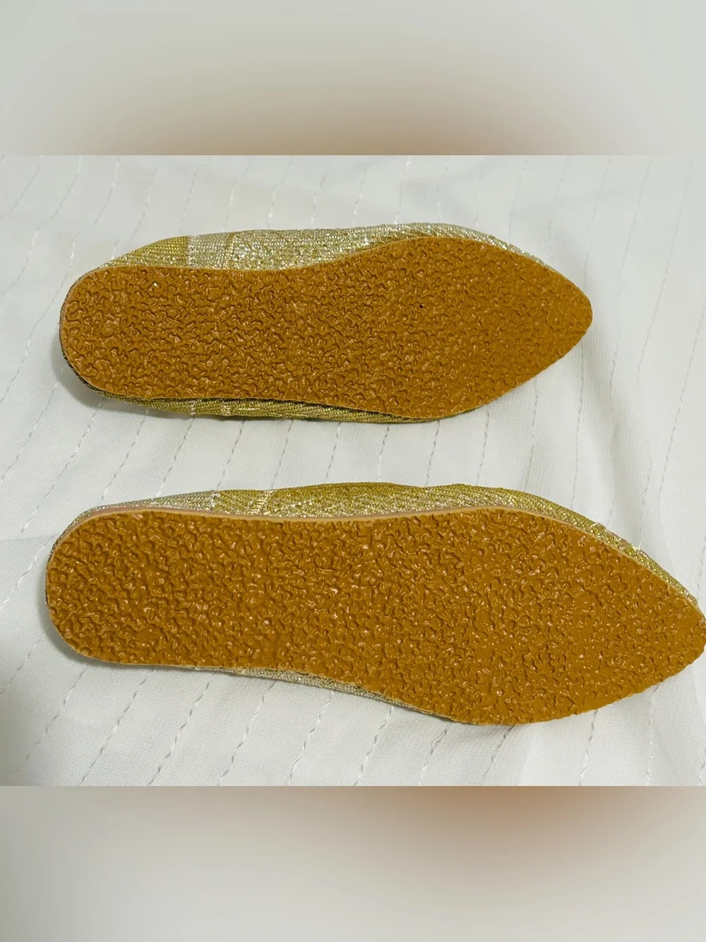Moroccan babouche slippers adorned with intricate embroidery and a pointed toe.